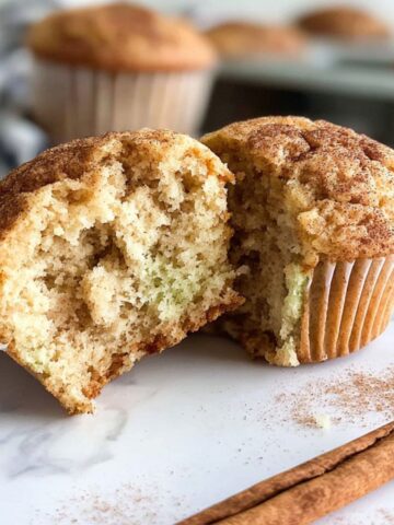 Homemade cinnamon protein muffins on a white kitchen counter
