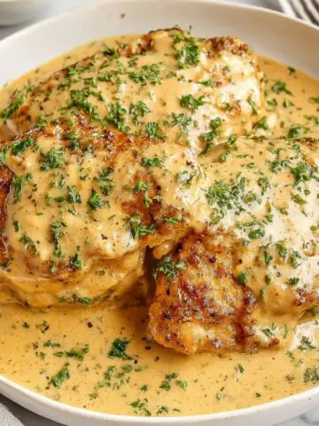 Homemade 3 ingredient crockpot chicken and gravy served on a kitchen table