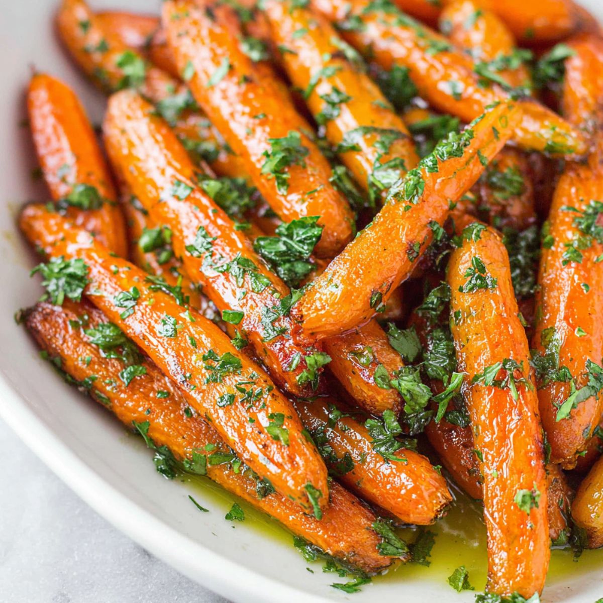 A plate of homemade honey butter glazed carrots on a white kitchen counter