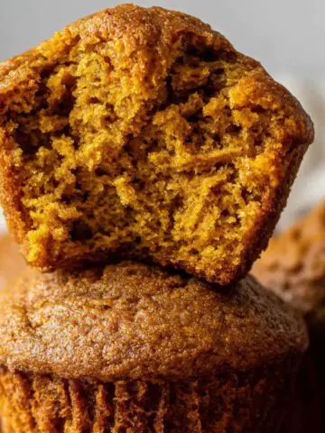 Homemade pumpkin muffins on a white kitchen counter,