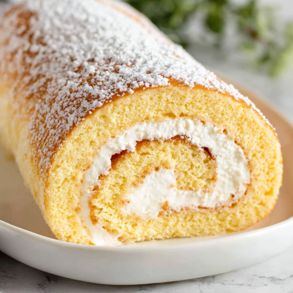 Vanilla swiss roll cake ingredients laid out casually on a kitchen counter